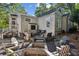 Secluded backyard with an outdoor tv area and a stone fire pit with chairs, perfect for entertaining at 250 Lakeview Ne Ave, Atlanta, GA 30305