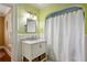 Bathroom features green walls, neutral white vanity and shower with white curtain at 250 Lakeview Ne Ave, Atlanta, GA 30305