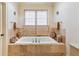 An elegant bathtub with marble surround and sconces at 250 Lakeview Ne Ave, Atlanta, GA 30305
