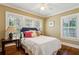 Bright bedroom featuring wood floors, plantation shutters, and warm neutral color scheme at 250 Lakeview Ne Ave, Atlanta, GA 30305