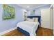 Cozy bedroom featuring light blue walls, hardwood floors, and a comfortable bed with stylish throw pillows at 250 Lakeview Ne Ave, Atlanta, GA 30305