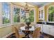 Warm breakfast nook featuring large windows, wicker chairs, and vintage chandelier lighting at 250 Lakeview Ne Ave, Atlanta, GA 30305