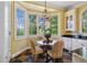 Cozy breakfast nook area with charming woven chairs, large windows, and stylish chandelier at 250 Lakeview Ne Ave, Atlanta, GA 30305