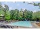 An expansive community swimming pool is framed by lush trees and offers a relaxing retreat at 250 Lakeview Ne Ave, Atlanta, GA 30305
