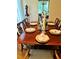 Dining room features set table and chairs for eight with vintage design and natural lighting at 250 Lakeview Ne Ave, Atlanta, GA 30305