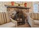 Living room fireplace with stone surround, metal screen, and ornate décor at 250 Lakeview Ne Ave, Atlanta, GA 30305