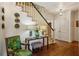 Foyer featuring hardwood floors, white staircase, and decorative wall art at 250 Lakeview Ne Ave, Atlanta, GA 30305