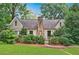Charming home featuring a stone chimney and mature landscaping at 250 Lakeview Ne Ave, Atlanta, GA 30305