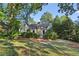 Charming home with lush landscaping, mature trees, and a stone chimney at 250 Lakeview Ne Ave, Atlanta, GA 30305