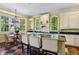 Bright kitchen with arched windows, black countertops, white cabinetry and a chandelier over the island at 250 Lakeview Ne Ave, Atlanta, GA 30305