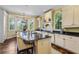 Charming kitchen with island seating, stainless steel appliances, white cabinets, and sunny bay windows at 250 Lakeview Ne Ave, Atlanta, GA 30305