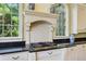 Kitchen features granite counters, gas range, tile backsplash, and beautiful natural light from arched windows at 250 Lakeview Ne Ave, Atlanta, GA 30305
