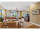 Comfortable living room featuring hardwood floors, large windows, neutral tones, and a decorative chandelier at 250 Lakeview Ne Ave, Atlanta, GA 30305