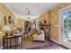 Cozy living room featuring a stone fireplace, patterned wallpaper, and French doors at 250 Lakeview Ne Ave, Atlanta, GA 30305