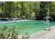 Large outdoor pool with lounge chairs surrounded by lush trees, diving board, and ladder for easy access at 250 Lakeview Ne Ave, Atlanta, GA 30305