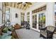 Bright sunroom with lots of natural light, a comfortable sofa, and wicker chairs at 250 Lakeview Ne Ave, Atlanta, GA 30305