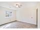 Cozy bedroom with gray carpet, white walls, window, and a ceiling fan at 3212 Huxley Ct, Duluth, GA 30096