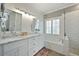 Elegant bathroom with marble vanity, soaking tub, and walk-in shower at 412 Mallory Cir, Loganville, GA 30052