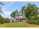 Two story house with stone fireplace and wrap around porch at 4130 Little Falls Dr, Cumming, GA 30041