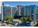 Aerial view of a modern high-rise building complex with a pool and parking at 44 Peachtree Ne Pl # 1622, Atlanta, GA 30309