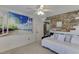 Bedroom featuring a daybed, beach-themed wall art, and ceiling fan at 4503 Mulberry Fields Ln, Auburn, GA 30011