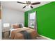 Bedroom with green accent wall and a cozy bed at 145 Gentle Breeze Ct, Temple, GA 30179