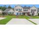 Two-story townhome with brick and siding exterior, landscaped lawn, and parking at 145 Gentle Breeze Ct, Temple, GA 30179