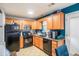 Kitchen with granite countertops, wood cabinets, and black appliances at 145 Gentle Breeze Ct, Temple, GA 30179