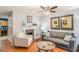 Living room with hardwood floors, fireplace, and comfortable seating at 145 Gentle Breeze Ct, Temple, GA 30179