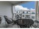 Private balcony with wicker chairs, rug, and view of other townhomes at 509 Burton Dr # 806, Alpharetta, GA 30009