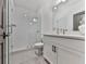 Modern bathroom with white vanity, a glass shower, and gray tile floors at 509 Burton Dr # 806, Alpharetta, GA 30009