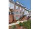 Townhome exterior with brick and white siding, featuring stairs and landscaping at 509 Burton Dr # 806, Alpharetta, GA 30009