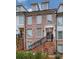 Brick front exterior of townhome with black railings and landscaping at 509 Burton Dr # 806, Alpharetta, GA 30009