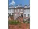 Three-story townhome building with brick and white accents, and black railings at 509 Burton Dr # 806, Alpharetta, GA 30009