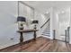 Bright foyer with hardwood floors, console table, and staircase at 509 Burton Dr # 806, Alpharetta, GA 30009