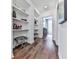 Hallway with built-in shelving, hardwood floors, and stylish ottomans at 509 Burton Dr # 806, Alpharetta, GA 30009