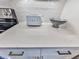 Close-up view of a kitchen counter with white quartz countertops, a SMEG toaster, and a decorative bowl at 509 Burton Dr # 806, Alpharetta, GA 30009