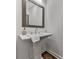 Elegant powder room with pedestal sink and wood-framed mirror at 509 Burton Dr # 806, Alpharetta, GA 30009