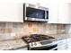 Modern kitchen features granite countertops and stainless steel appliances at 2381 Willington Shoals Pl # 21, Smyrna, GA 30080