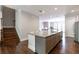 Large kitchen island with granite countertop and taupe cabinets at 2381 Willington Shoals Pl # 21, Smyrna, GA 30080