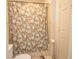 Bathroom with floral shower curtain and tile surround at 1250 Parkwood Cir # 2312, Atlanta, GA 30339