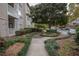 Landscaped walkway leading to apartment building and parking at 1250 Parkwood Cir # 2312, Atlanta, GA 30339