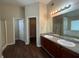 Bright bathroom featuring double sinks, granite counters, tub, and a glass shower at 308 Jarrod Oaks Ct, Loganville, GA 30052