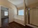 Bathroom featuring a soaking tub, glass shower, and neutral tones at 308 Jarrod Oaks Ct, Loganville, GA 30052