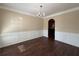 Elegant dining room featuring hardwood floors, chair-rail molding, and a classic chandelier at 308 Jarrod Oaks Ct, Loganville, GA 30052