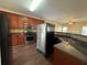 Spacious kitchen featuring granite countertops, stainless steel appliances and wood flooring at 308 Jarrod Oaks Ct, Loganville, GA 30052