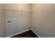 Laundry room featuring dark floors and neutral paint at 308 Jarrod Oaks Ct, Loganville, GA 30052