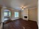 Comfortable living room featuring a fireplace, ceiling fan, and great natural light at 308 Jarrod Oaks Ct, Loganville, GA 30052