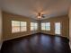 Spacious living room featuring a ceiling fan, hardwood floors and lots of natural light at 308 Jarrod Oaks Ct, Loganville, GA 30052