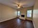 Cozy living room featuring a fireplace, ceiling fan, and lots of natural light at 308 Jarrod Oaks Ct, Loganville, GA 30052